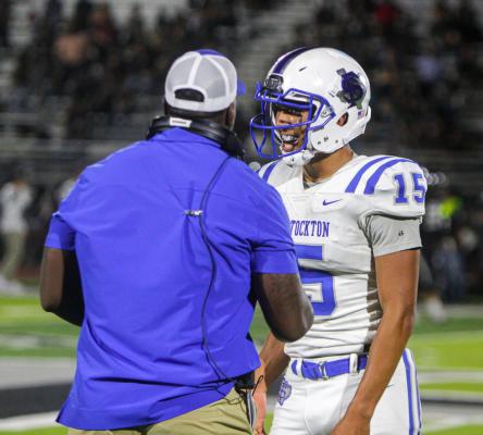Senior Zane Hodges is embraced by coach Zack Roberson following a sack against El Paso Horizon on Sept. 9. Hodges matched his seven tackles, three sacks, and one fumble recovery against the Scorpions this past Friday versus the Lobos. Photo by Nathan Heuer