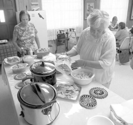 Members line up at the Senior Center for a previous pot luck luncheon.