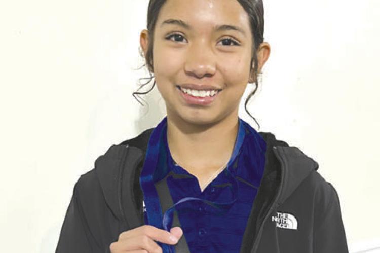 Alexis Rodriguez poses with her medal. Photos by Enissa Sanchez