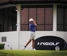 Bradye Barragan Teeing off hole 1 of the PGA National’s Champion Course in the rain. Photo by Tristian Barragan